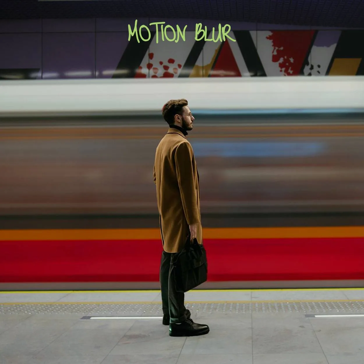Motion blur example: a man stands still while a train speeds past